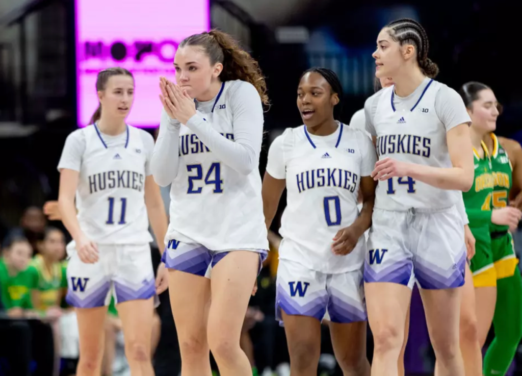 The University of Washington women's basketball team's Elle Ladine, Sayvia Sellers, Dalayah Daniels and Chloe Briggs walk back to the bench against Oregon on March 2, 2025 at Alaska Airlines Arena in Seattle, Wash.